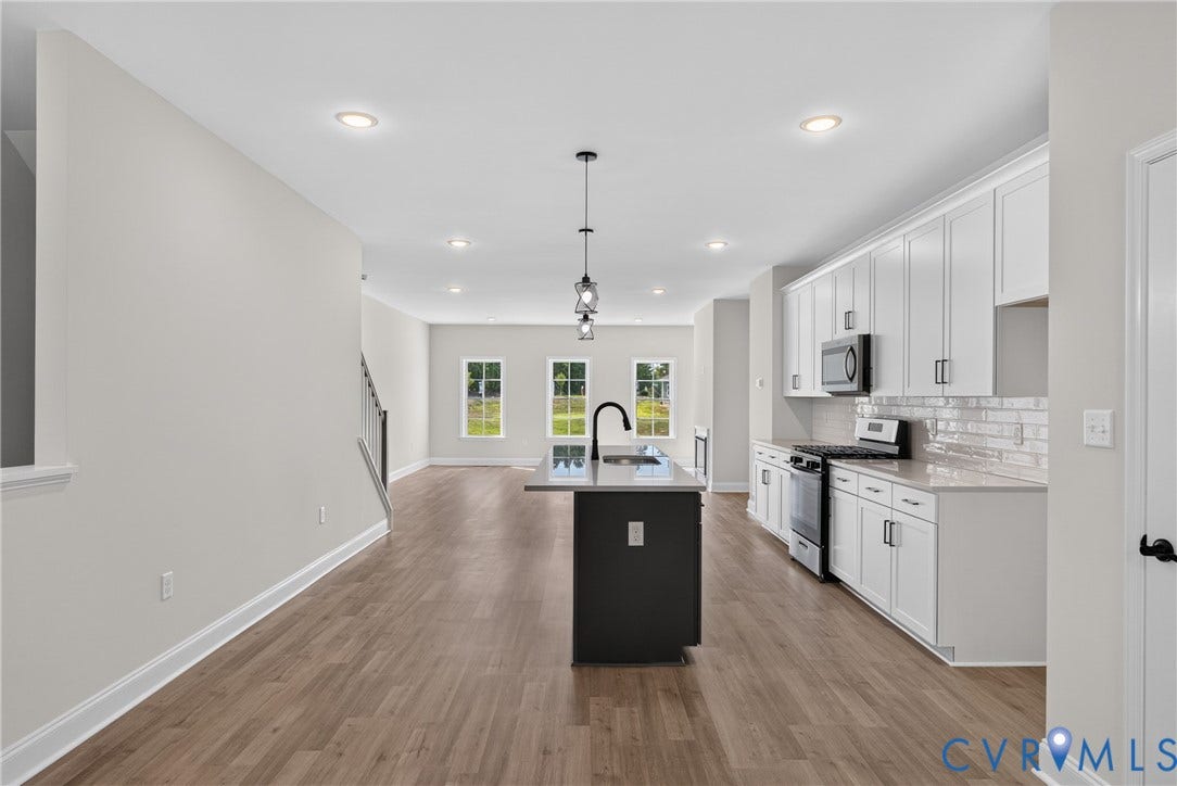 6541 Hardee Haven Place, Midlothian, VA 23112 Kitchen featuring a central island with sink, stainless steel appliances, white cabinetry, and wood-finish flooring