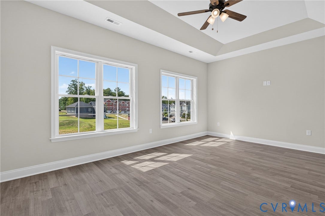 6541 Hardee Haven Place, Midlothian, VA 23112 Tray ceiling, wood-finish flooring, two large windows, white trim, and a ceiling fan