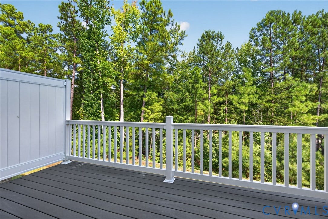 6541 Hardee Haven Place, Midlothian, VA 23112 Composite decking with a privacy wall and white baluster railing, set against a backdrop of mature trees