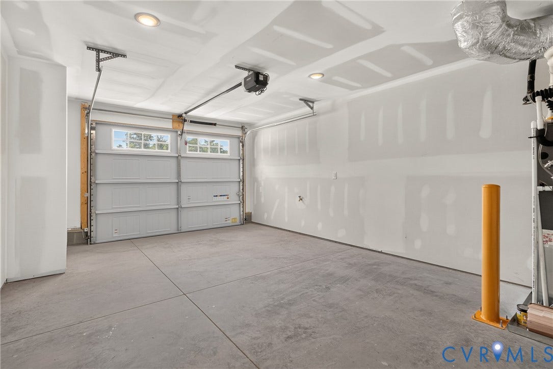 6541 Hardee Haven Place, Midlothian, VA 23112 Concrete flooring, white walls, and a multi-panel garage door with upper window inserts