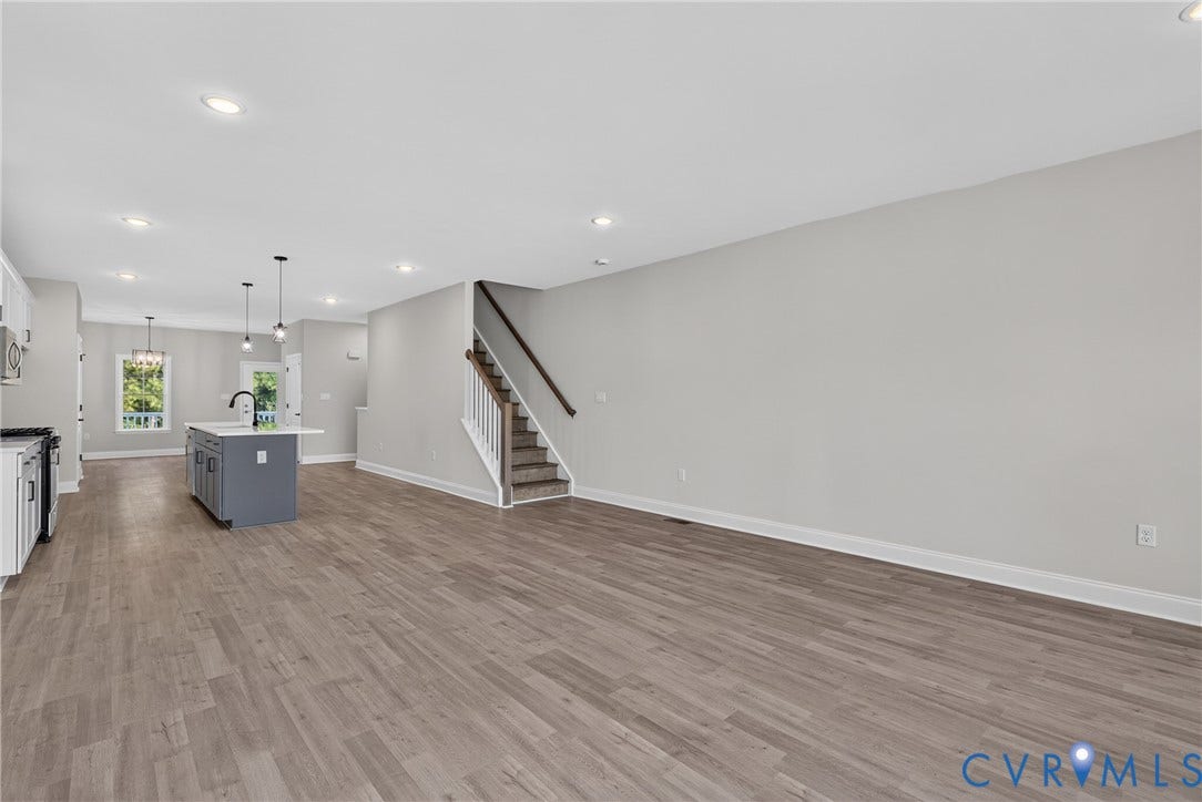 6541 Hardee Haven Place, Midlothian, VA 23112 Expansive open-concept layout featuring wood-finish flooring, recessed lighting, and a contemporary kitchen island with a basin sink
