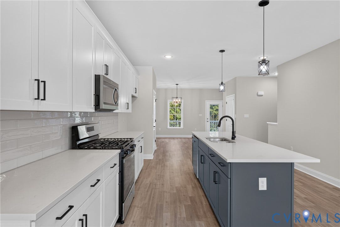 6541 Hardee Haven Place, Midlothian, VA 23112 Kitchen featuring white cabinetry, light gray subway tile backsplash, stainless steel appliances, a center island with a sink, and wood-finish flooring