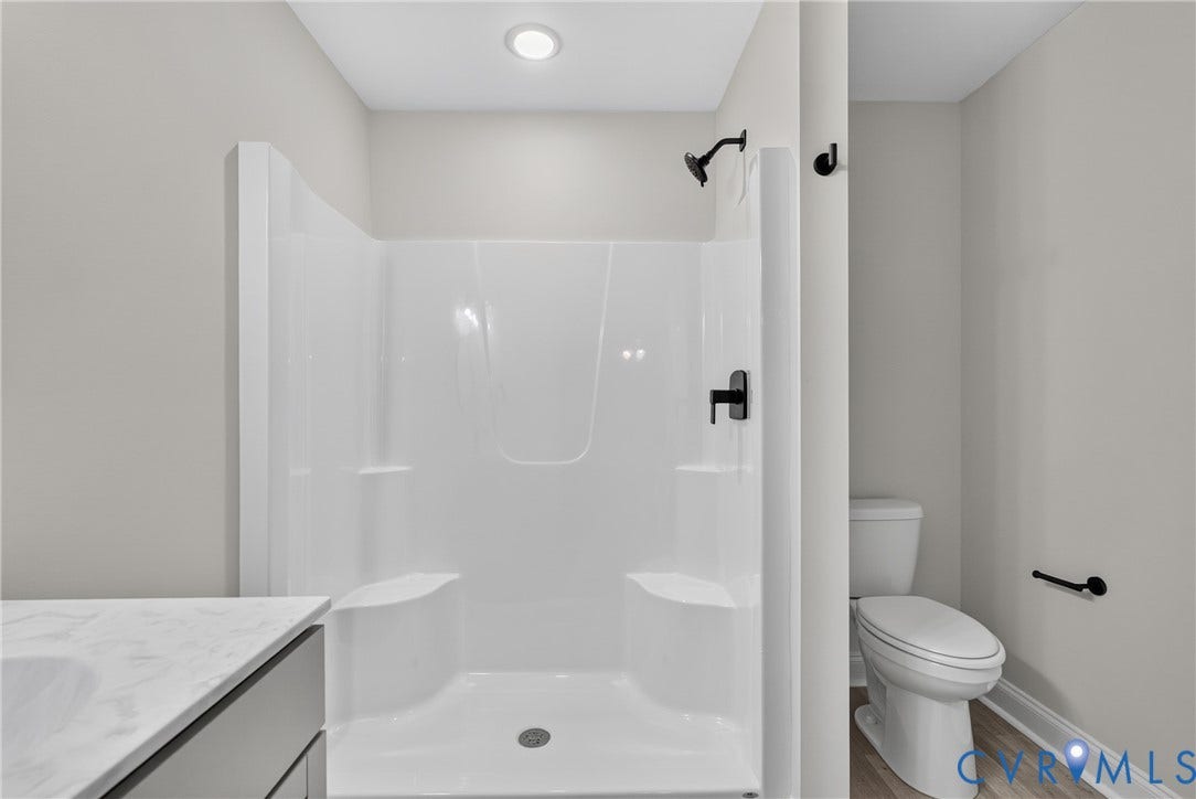 6541 Hardee Haven Place, Midlothian, VA 23112 Integrated shower unit with built-in seating, matte black shower fixtures, recessed lighting, and a white toilet