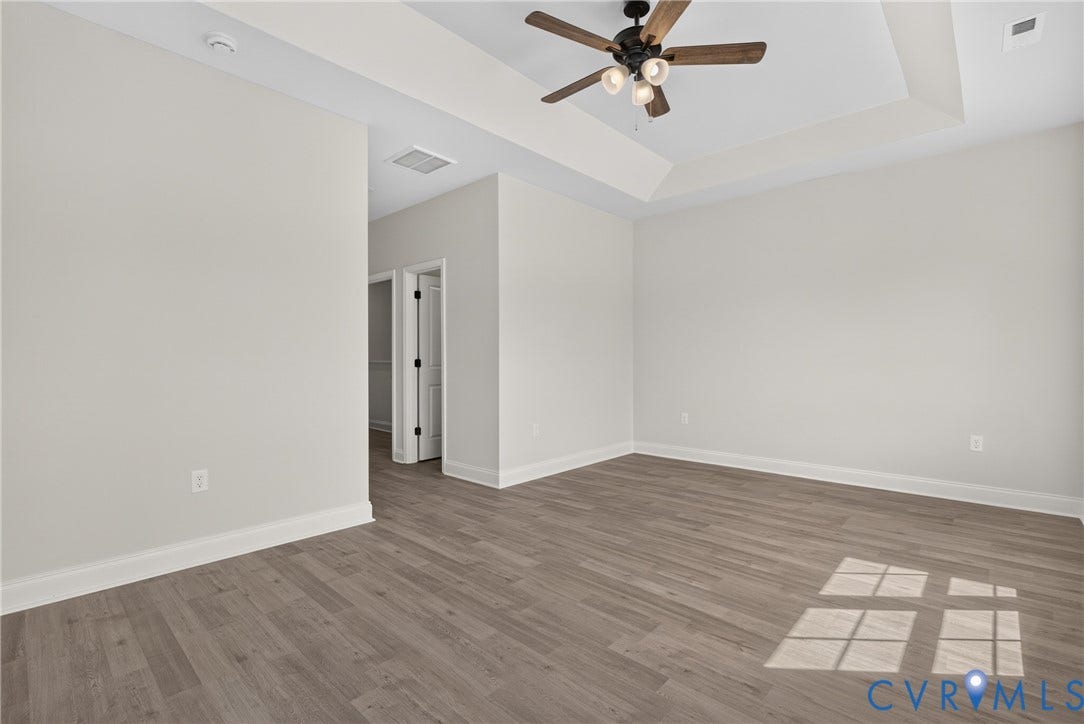 6541 Hardee Haven Place, Midlothian, VA 23112 Tray ceiling with an attached ceiling fan, light wood-finish flooring, and crisp white baseboards