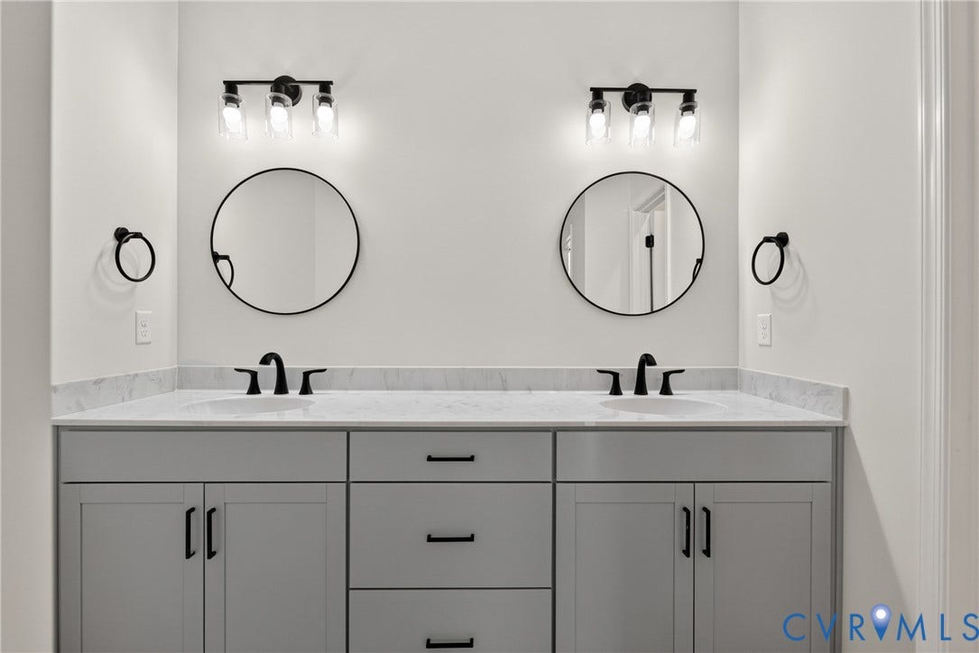 6541 Hardee Haven Place, Midlothian, VA 23112 Double vanity with stone countertop, undermount sinks, matte black fixtures, and circular mirrors