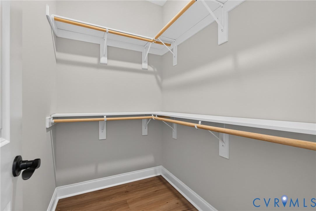 6545 Hardee Haven Place, Midlothian, VA 23112 Walk-in closet with wood-finish flooring, white shelving, and wood rods