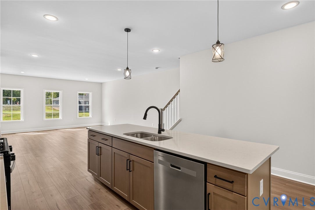 6545 Hardee Haven Place, Midlothian, VA 23112 Kitchen island with a double basin sink, stainless steel dishwasher, and light-toned countertop