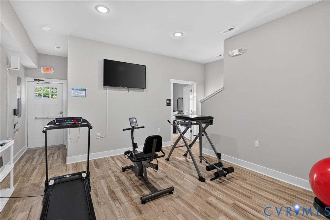 6545 Hardee Haven Place, Midlothian, VA 23112 Recessed ceiling lighting, wood-finish flooring, light gray wall paint, white trim, and a wall-mounted television