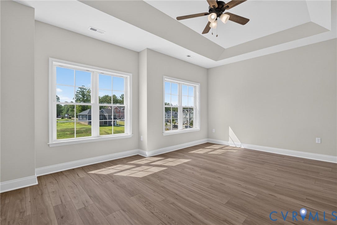 6545 Hardee Haven Place, Midlothian, VA 23112 Tray ceiling with a ceiling fan, wood-finish flooring, and multiple windows