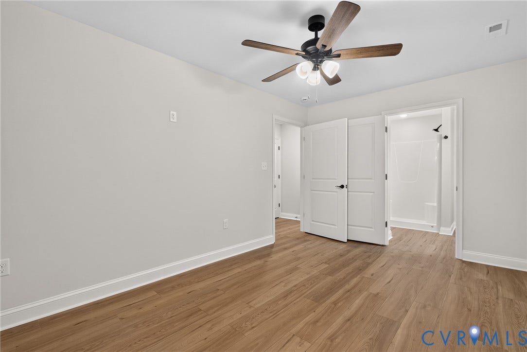 6545 Hardee Haven Place, Midlothian, VA 23112 Wood-finish flooring, white trim, and a ceiling fan with integrated lighting