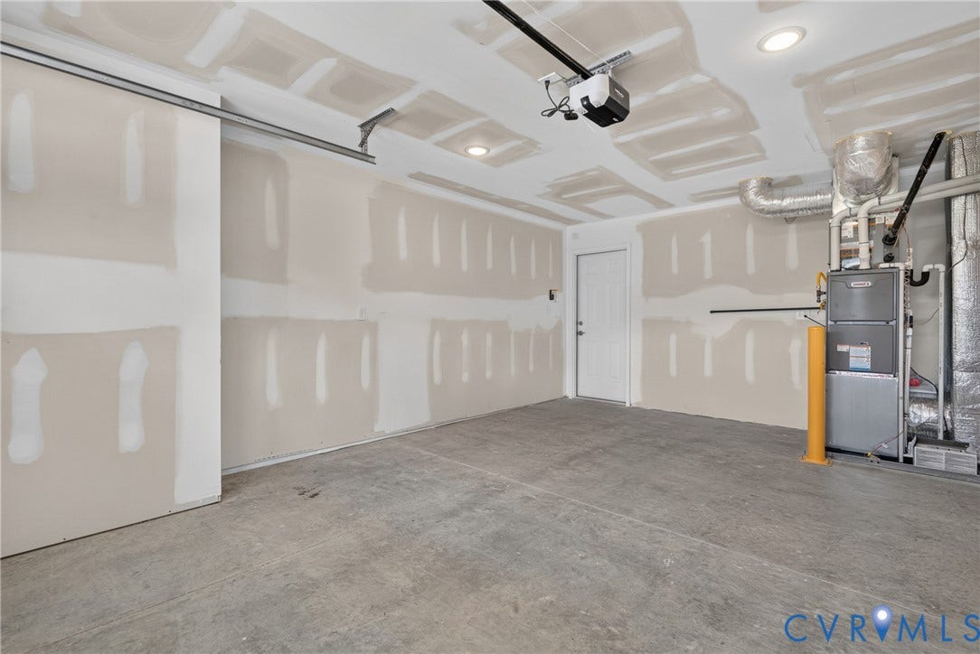 6545 Hardee Haven Place, Midlothian, VA 23112 Unfinished garage with a concrete floor, built-in overhead garage door opener, and recessed ceiling lighting