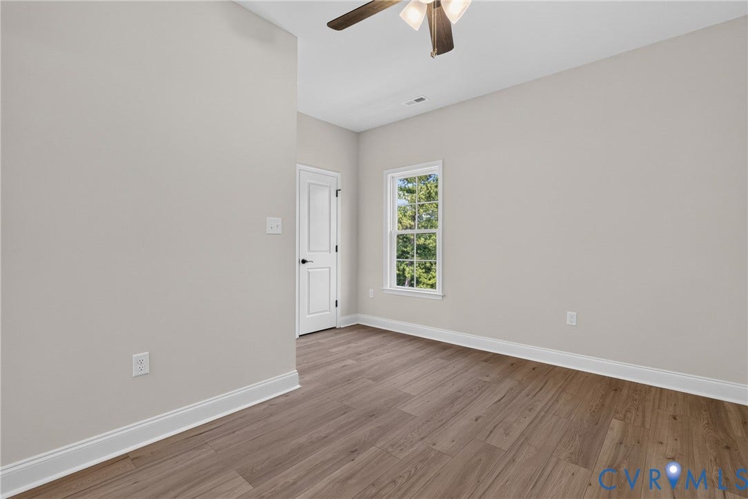 6545 Hardee Haven Place, Midlothian, VA 23112 Wood-finish flooring with white trim, a double-panel door, and a single window