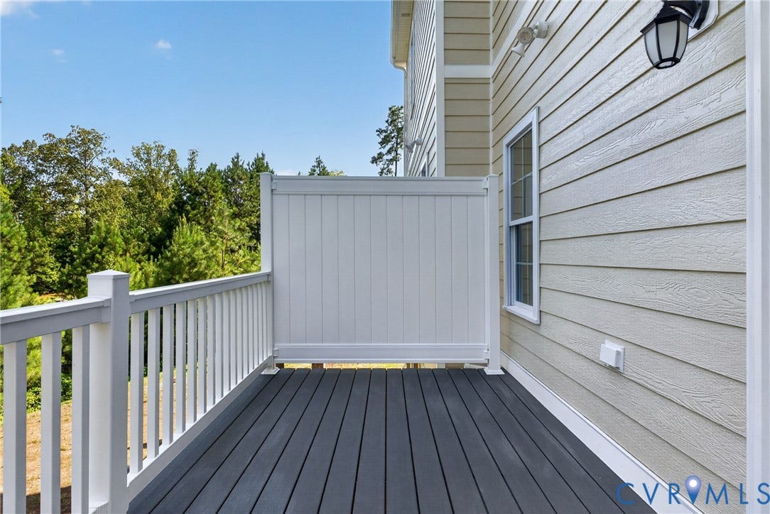 6545 Hardee Haven Place, Midlothian, VA 23112 Exterior deck featuring dark composite decking, white railing, and a privacy panel
