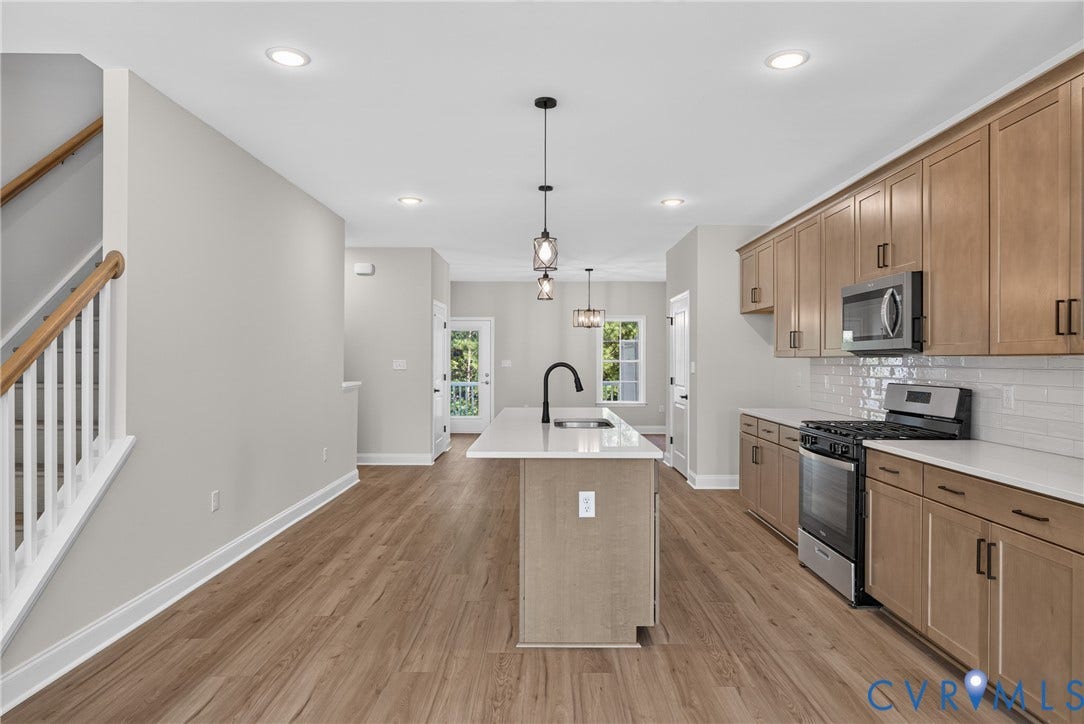6545 Hardee Haven Place, Midlothian, VA 23112 Open-concept living space with wood-finish flooring, recessed lighting, and a staircase with white spindles and a wood handrail
