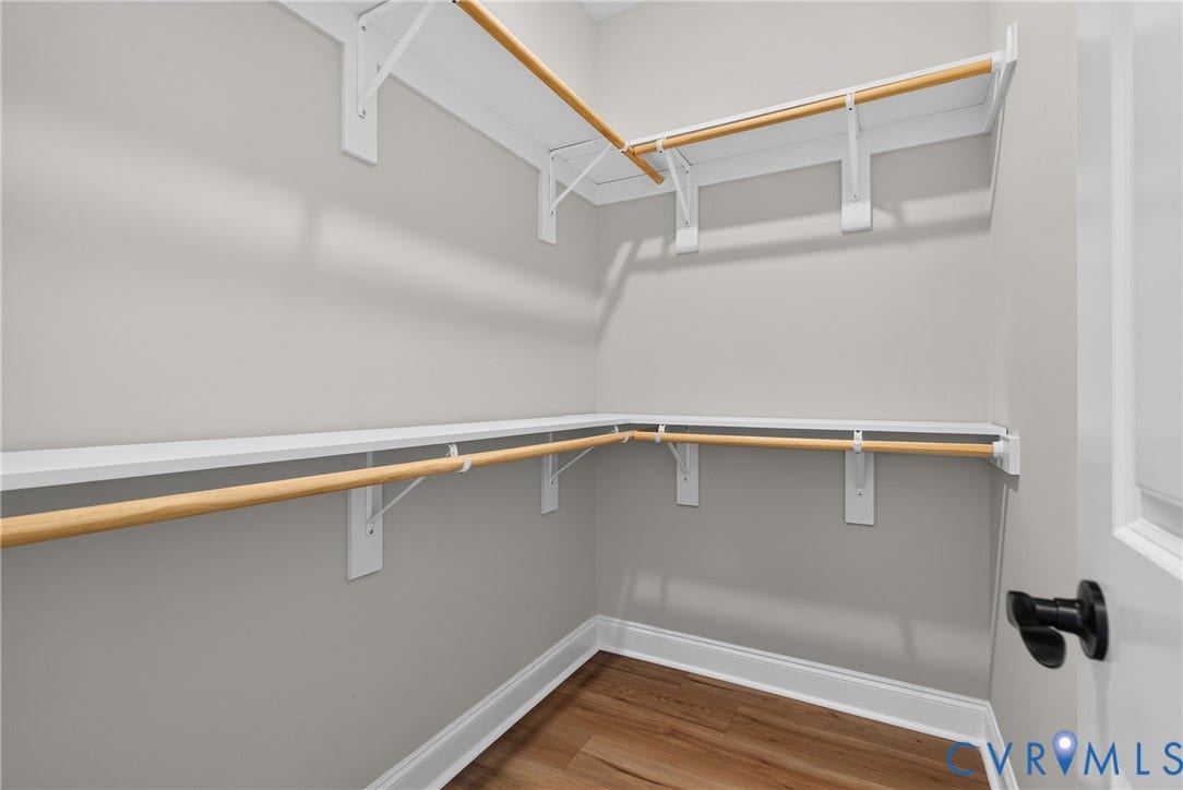 6545 Hardee Haven Place, Midlothian, VA 23112 Walk-in closet with wood-finish flooring, white shelving, and wood hanging rods