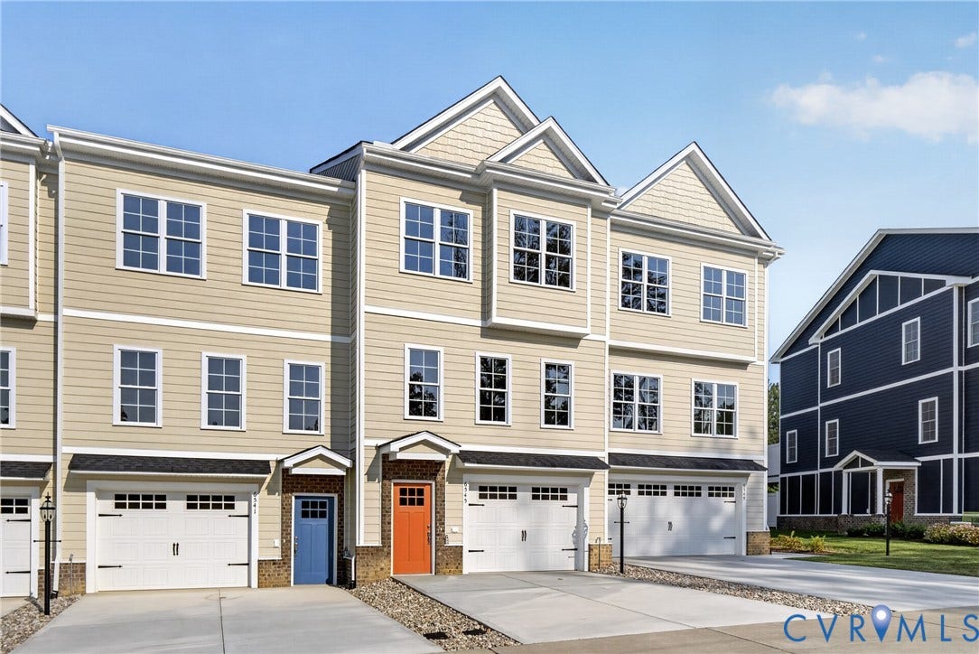 6545 Hardee Haven Place, Midlothian, VA 23112 Multi-level townhouse exterior featuring light-colored siding, multiple windows, attached garages, and distinctive front entry doors