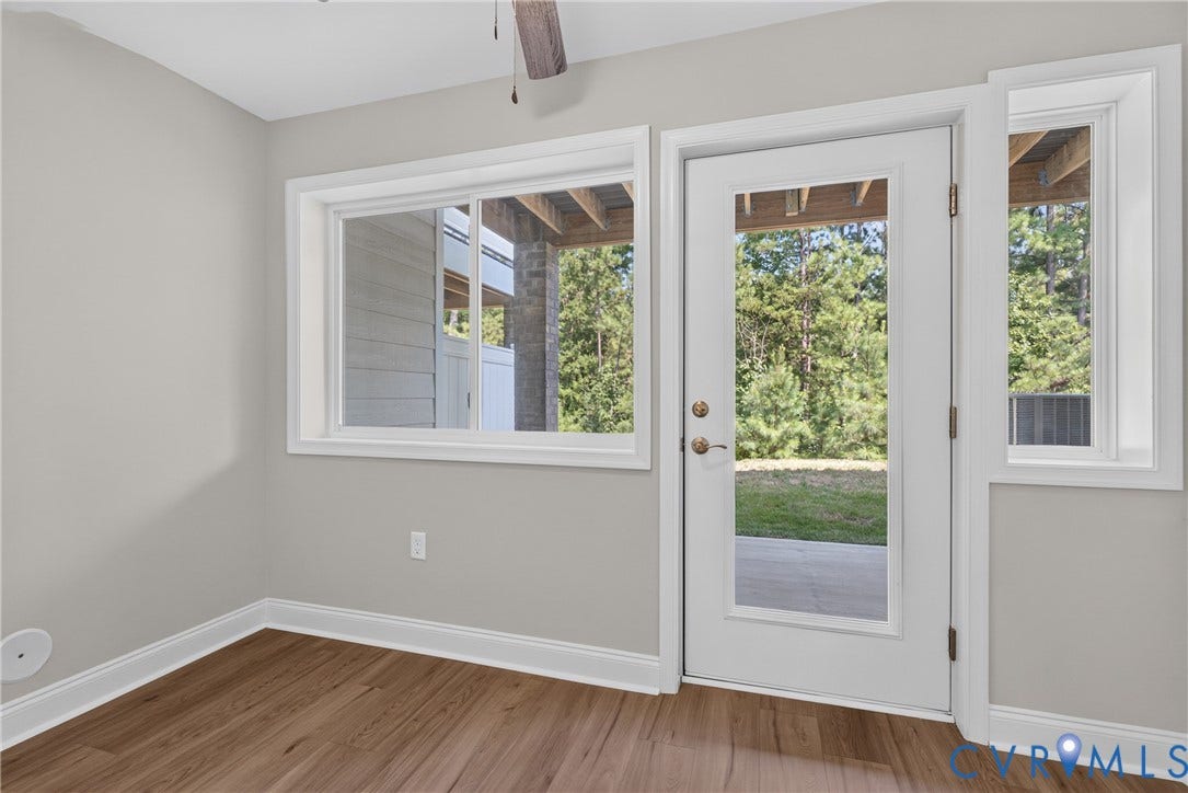 6545 Hardee Haven Place, Midlothian, VA 23112 Wood-finish flooring, light gray wall paint, white trim, glass-paned door, and large windows offering exterior visibility