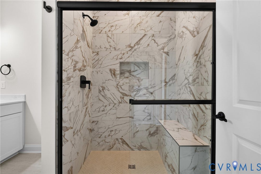 6545 Hardee Haven Place, Midlothian, VA 23112 Spacious shower featuring full-height marble-look tile, a built-in bench, and a recessed niche