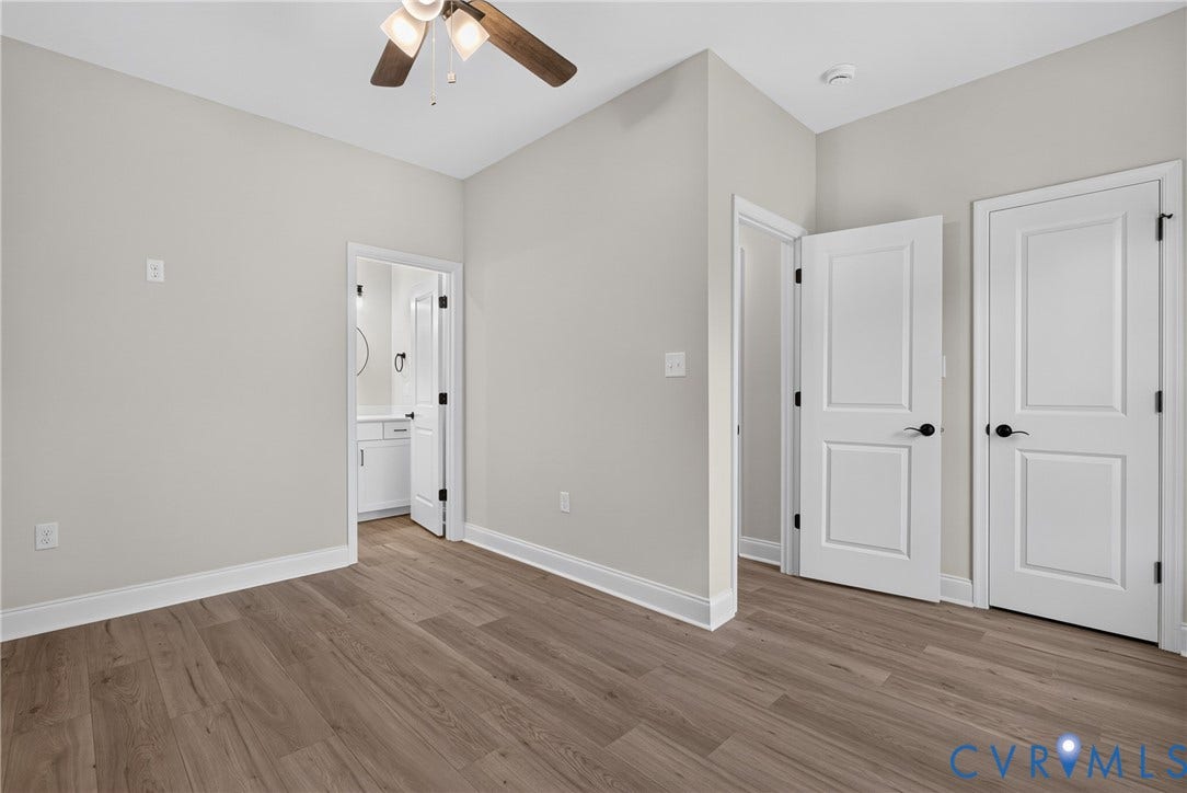 6545 Hardee Haven Place, Midlothian, VA 23112 Wood-finish flooring, ceiling fan with integrated lighting, paneled interior doors with matte black hardware, and crisp white trim