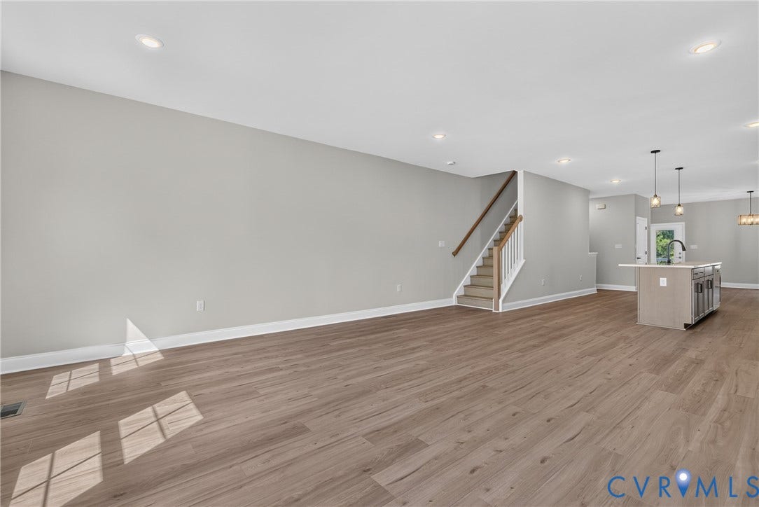 6545 Hardee Haven Place, Midlothian, VA 23112 Open-concept living space with wood-finish flooring, recessed lighting, and a staircase with wood handrails