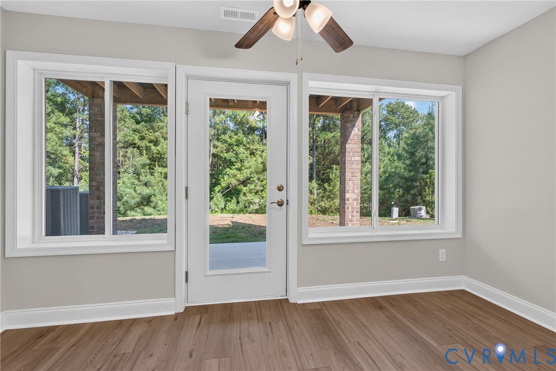 6549 Hardee Haven Place, Midlothian, VA 23112 Wood-finish flooring, white trim, ceiling fan, glass-paneled door, and multiple windows