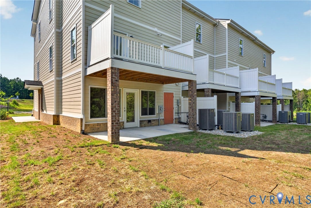 6549 Hardee Haven Place, Midlothian, VA 23112 Exterior featuring composite siding, a private balcony with white railings, a ground-level patio, and brick columns