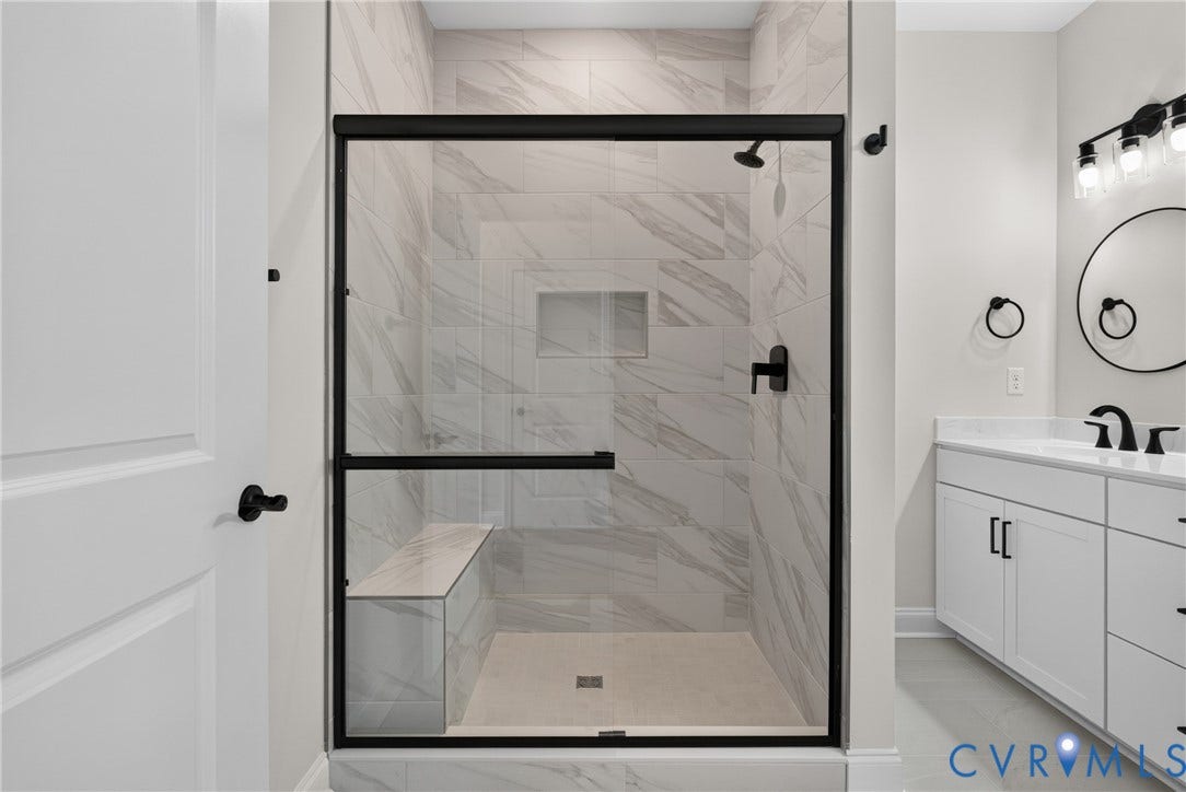 6549 Hardee Haven Place, Midlothian, VA 23112 Walk-in shower with a built-in bench, tiled walls, and a recessed niche