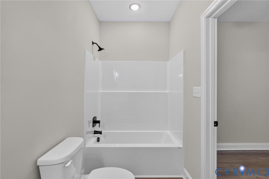 6549 Hardee Haven Place, Midlothian, VA 23112 Bathtub and shower combination with matte black fixtures, white toilet, and recessed ceiling lighting