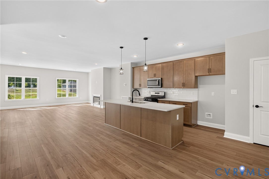 6549 Hardee Haven Place, Midlothian, VA 23112 Open-concept kitchen and living area featuring wood-finish flooring, recessed lighting, and ample natural light from multiple windows