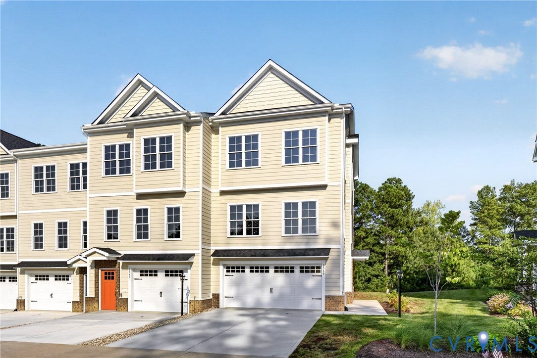 6549 Hardee Haven Place, Midlothian, VA 23112 Three-story townhome with light-toned siding, attached garages, and a prominent orange entry door