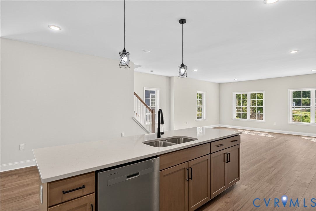 6549 Hardee Haven Place, Midlothian, VA 23112 Kitchen island with a light-toned countertop, stainless steel double basin sink, and integrated dishwasher