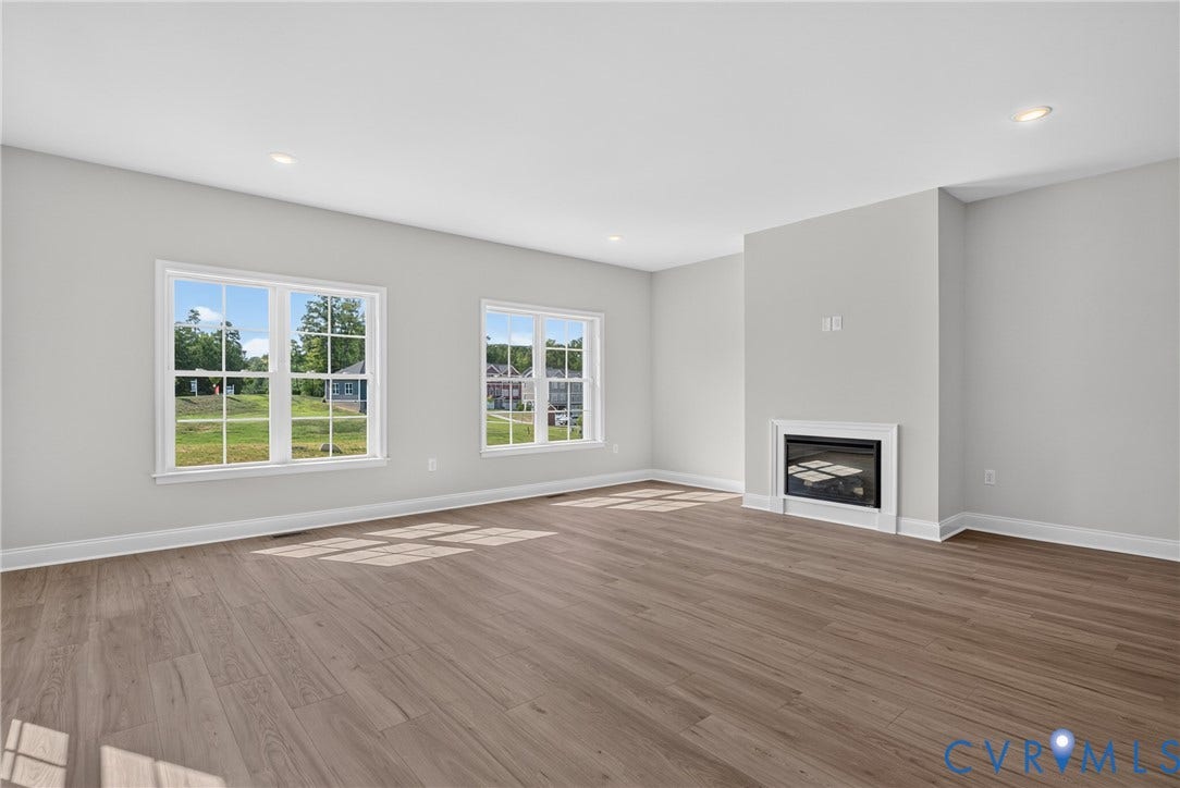 6549 Hardee Haven Place, Midlothian, VA 23112 Wood-finish flooring, recessed lighting, and a built-in fireplace with a white mantel and surround