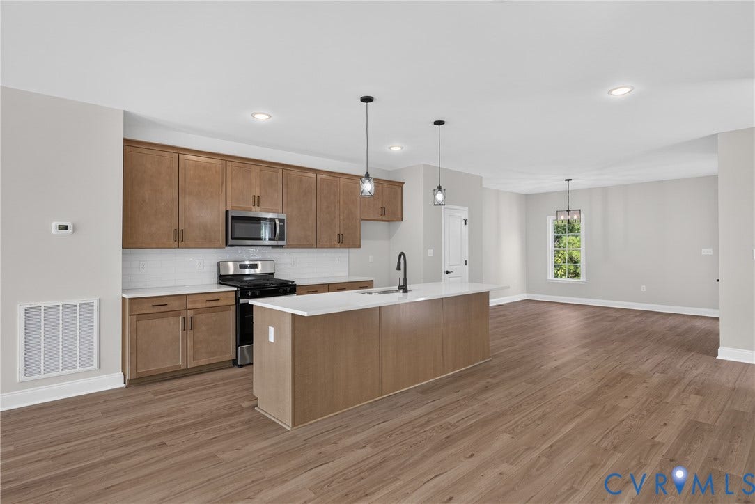 6549 Hardee Haven Place, Midlothian, VA 23112 Open-concept kitchen with wood-finish flooring, recessed lighting, and a kitchen island with a built-in sink