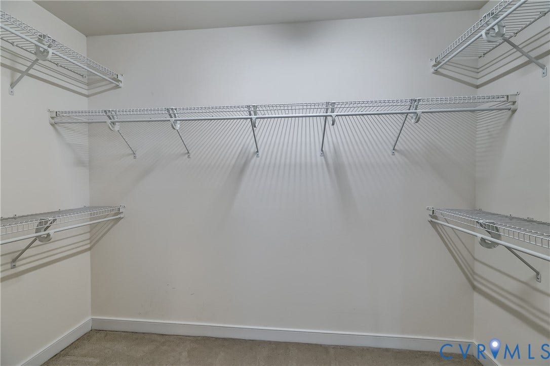Walk-in closet featuring tons of options.
