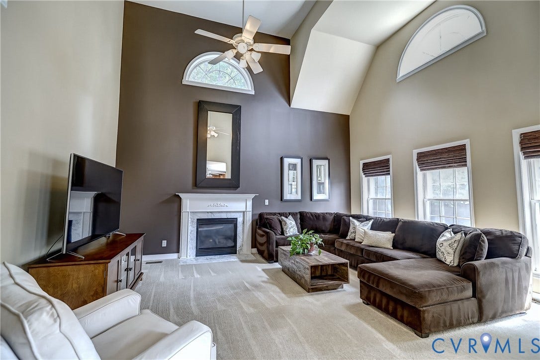 Soaring ceilings accented by a paladium window make this the perfect place for movie night or just to hang with the gang.