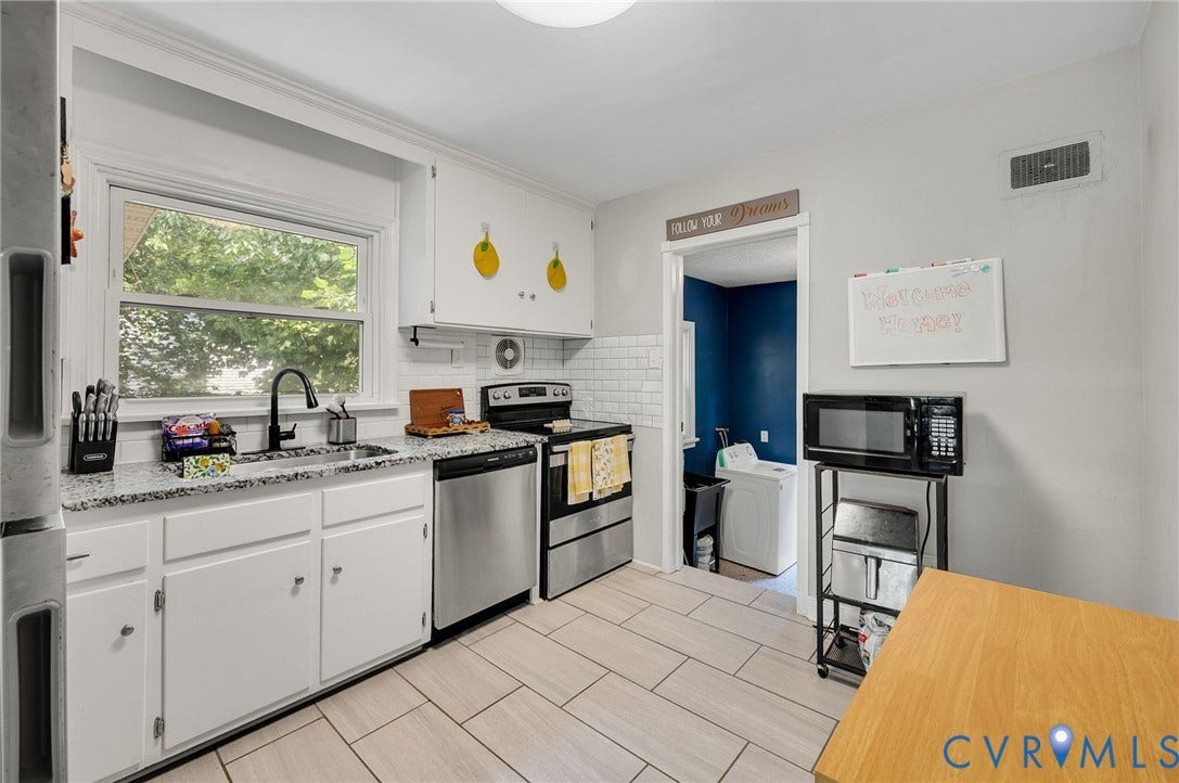 4819 Arundel Avenue, Chesterfield, VA 23234 White cabinetry, stone-finish countertops, stainless steel appliances, subway tile backsplash, and light-toned tile flooring