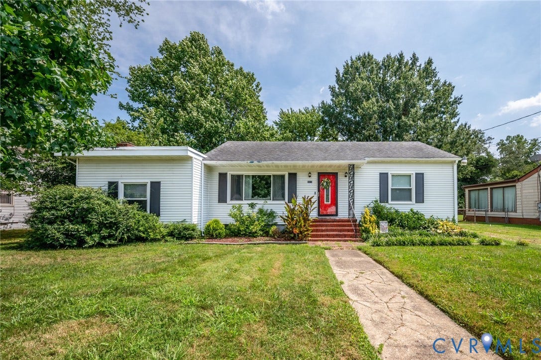 4819 Arundel Avenue, Chesterfield, VA 23234 White siding exterior with dark shutters, red entry door, established landscaping, and a concrete pathway