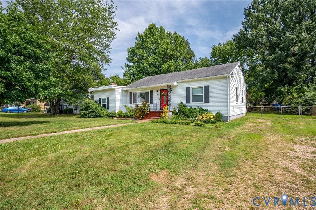 4819 Arundel Avenue, Chesterfield, VA 23234 White siding exterior with dark shutters, a bright red front door, and mature surrounding trees