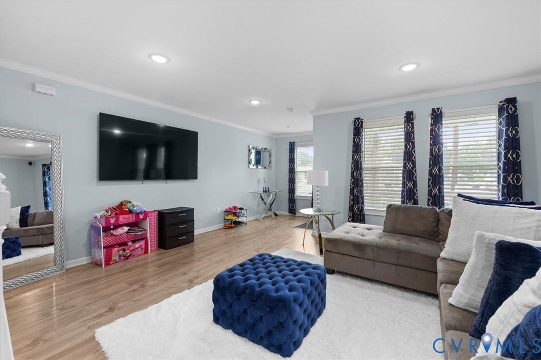 Recessed lighting, crown molding, wood-finish flooring, and multiple windows with blinds