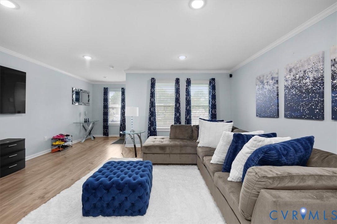 Wood-finish flooring, recessed lighting, crown molding, and window blinds