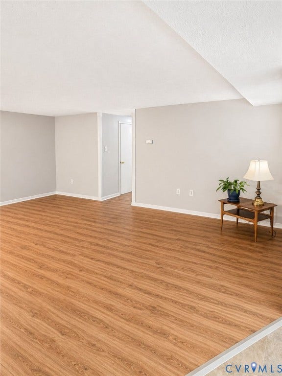 View of living room from dining room toward central hall
