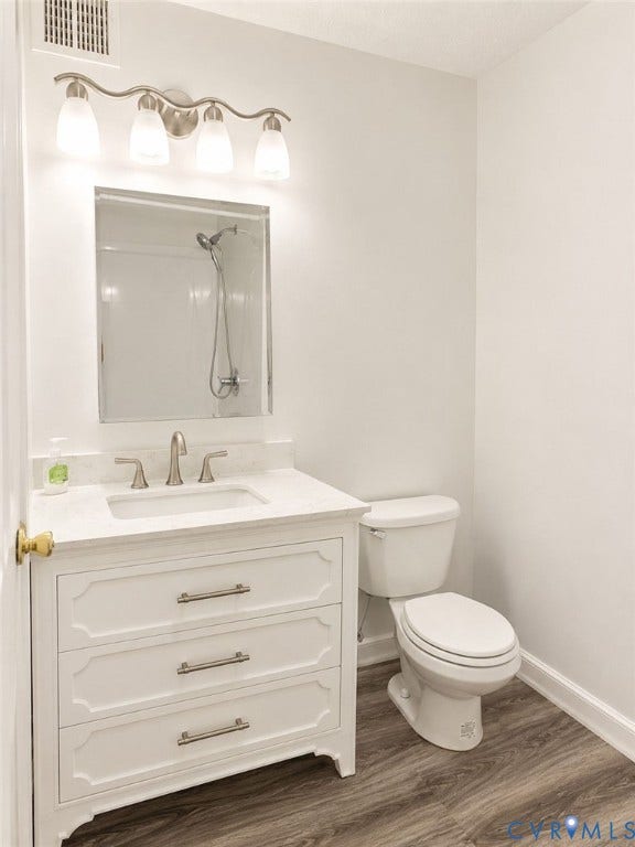 Primary Bathroom with vanity, bright lighting, stand-alone shower, no tub.