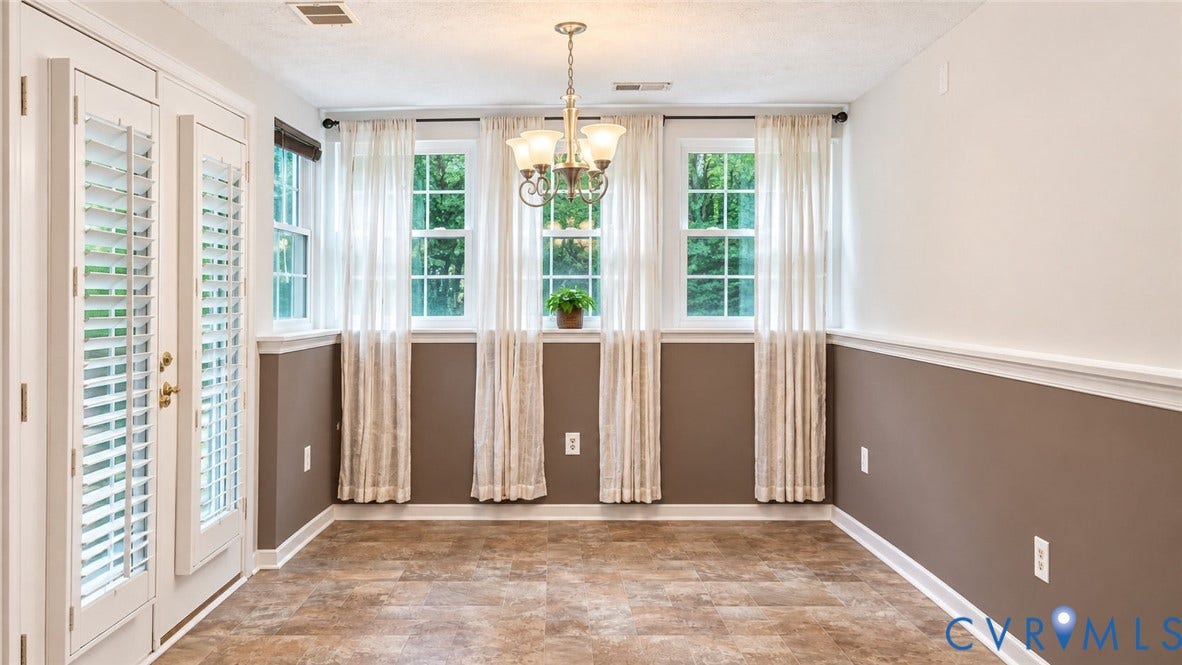 Lots of natural light through 5 windows.  French doors with plantation shutters open to covered patio.
