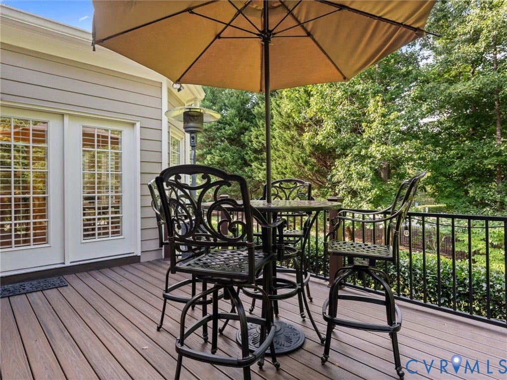 15706 Fox Marsh Drive, Moseley, VA 23120 Expansive exterior deck featuring durable composite decking, black metal railing, and white French doors
