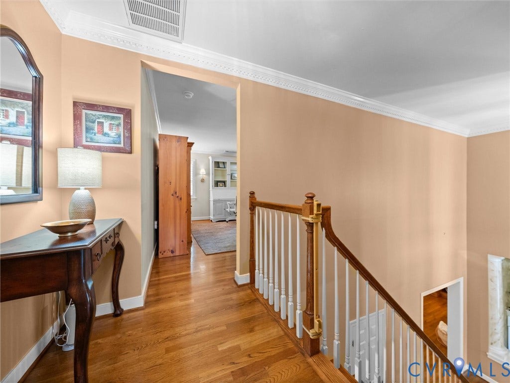 15706 Fox Marsh Drive, Moseley, VA 23120 Hardwood flooring, decorative crown molding, and a traditional staircase with turned balusters