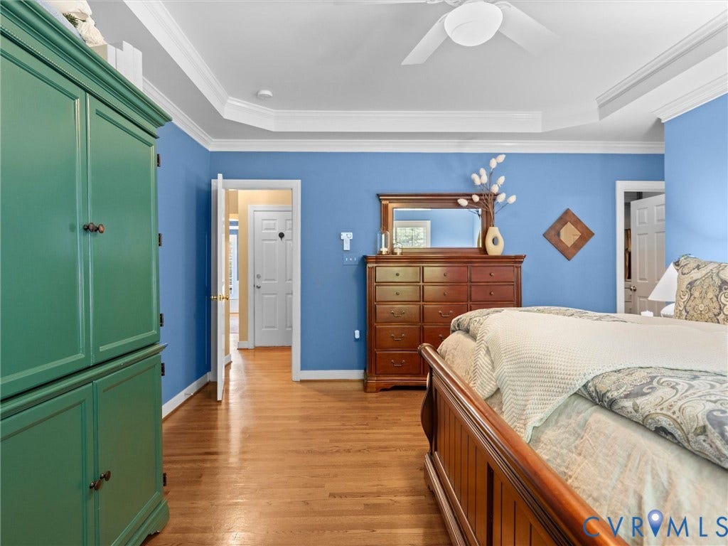 15706 Fox Marsh Drive, Moseley, VA 23120 Tray ceiling with a ceiling fan, wood-finish flooring, and white trim