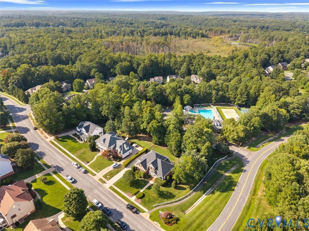15706 Fox Marsh Drive, Moseley, VA 23120 Aerial perspective highlighting residential properties, lush green landscaping, and a community pool with tennis courts