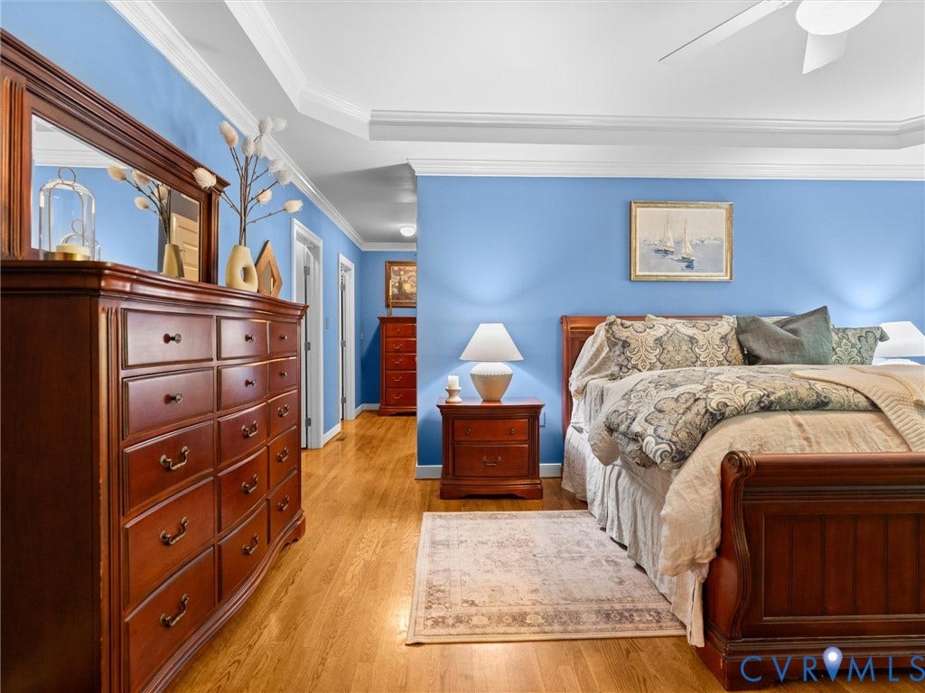 15706 Fox Marsh Drive, Moseley, VA 23120 Wood-finish flooring with a tray ceiling and crown molding