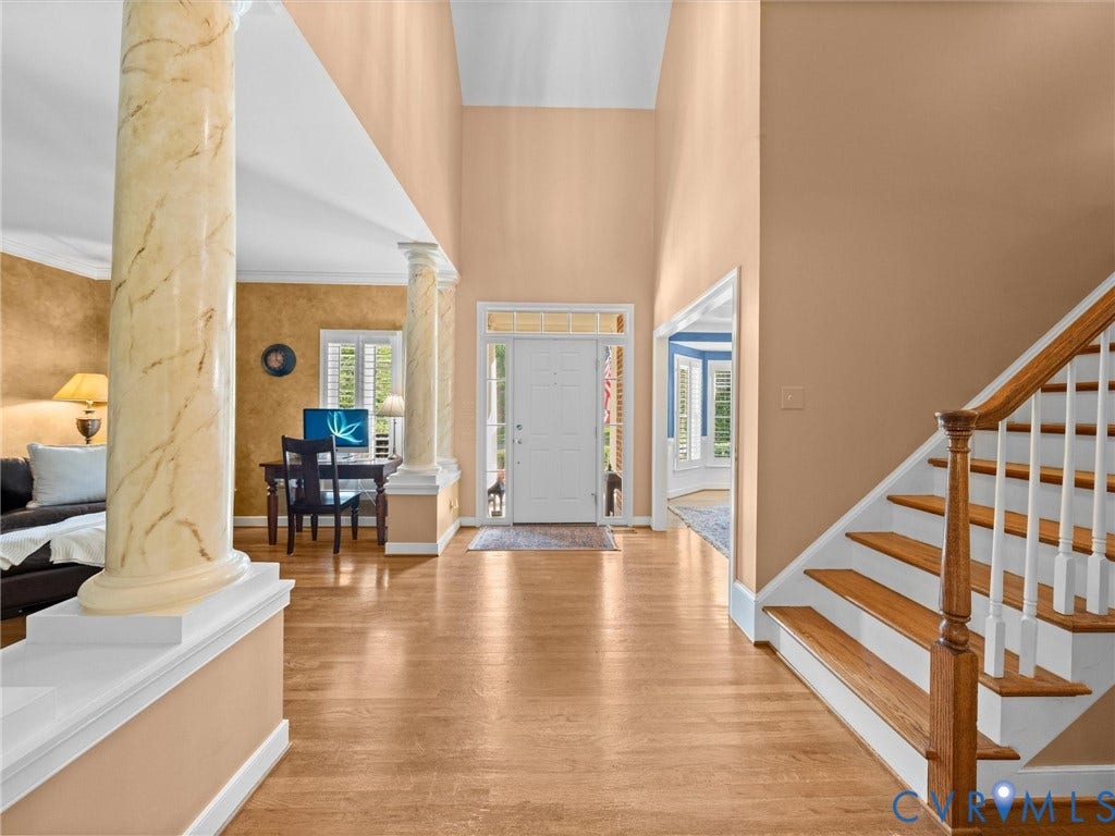15706 Fox Marsh Drive, Moseley, VA 23120 Two-story entryway with wood-finish flooring, a white front door with transom window, and a wood staircase with white risers