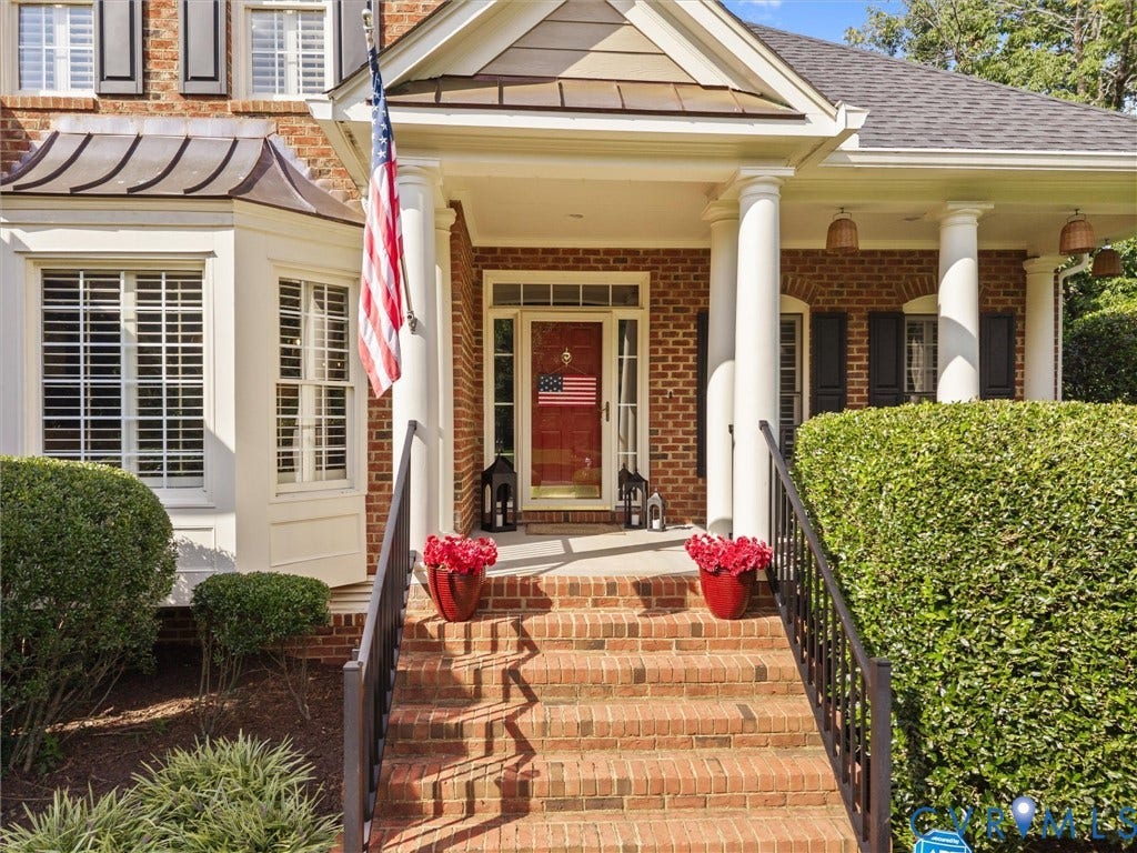 15706 Fox Marsh Drive, Moseley, VA 23120 Brick exterior with a covered porch, bay window, and a red entry door